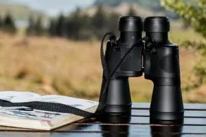 A pair of binoculars resting on a table outside.