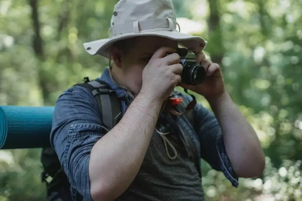 Man taking photo of bird