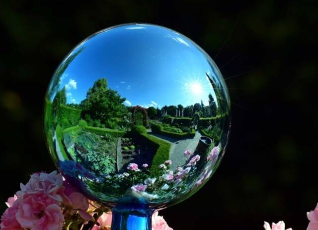 A ball mirror setup in a garden.