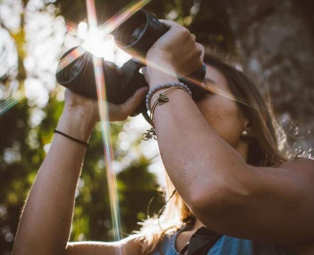 A woman birdwatching with binoculars.