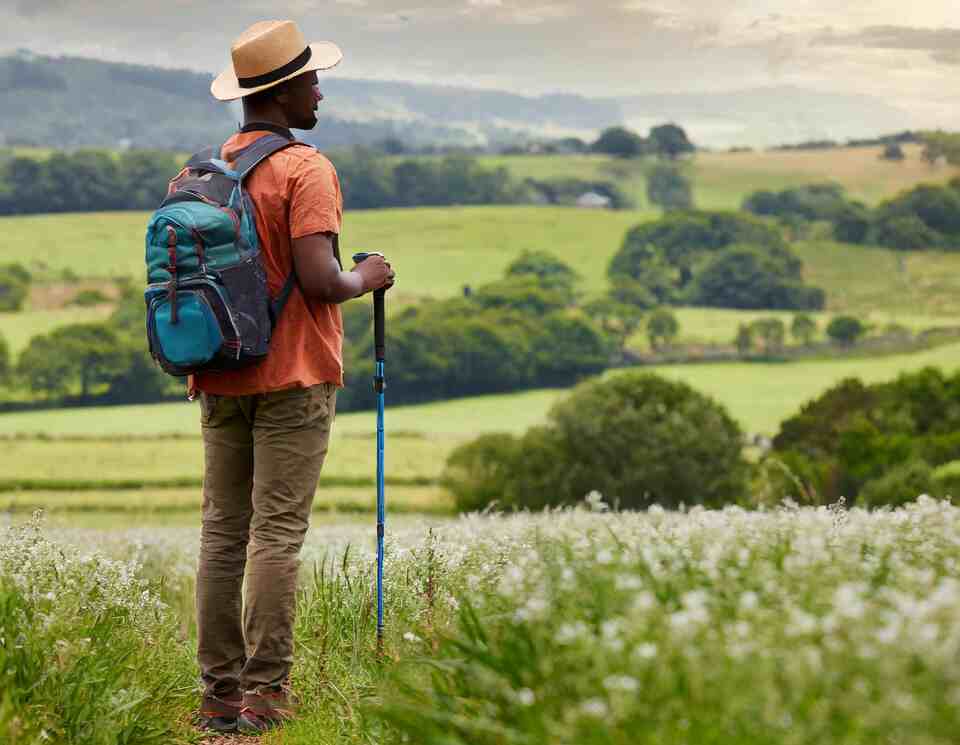 A person birdwatching in the country.